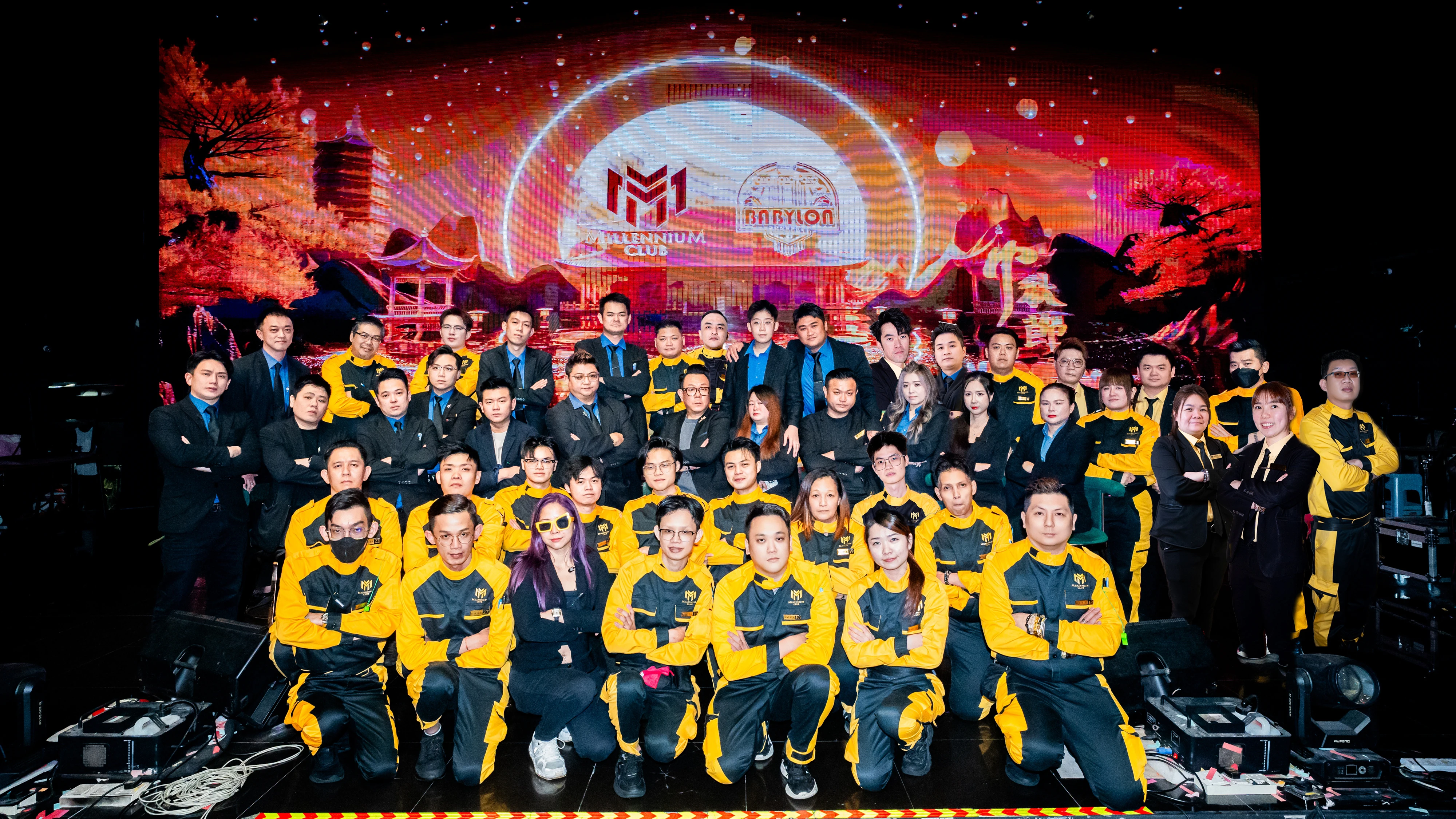 Large group gathered on the stage for a celebration at Millennium Club KL, Bukit Bintang