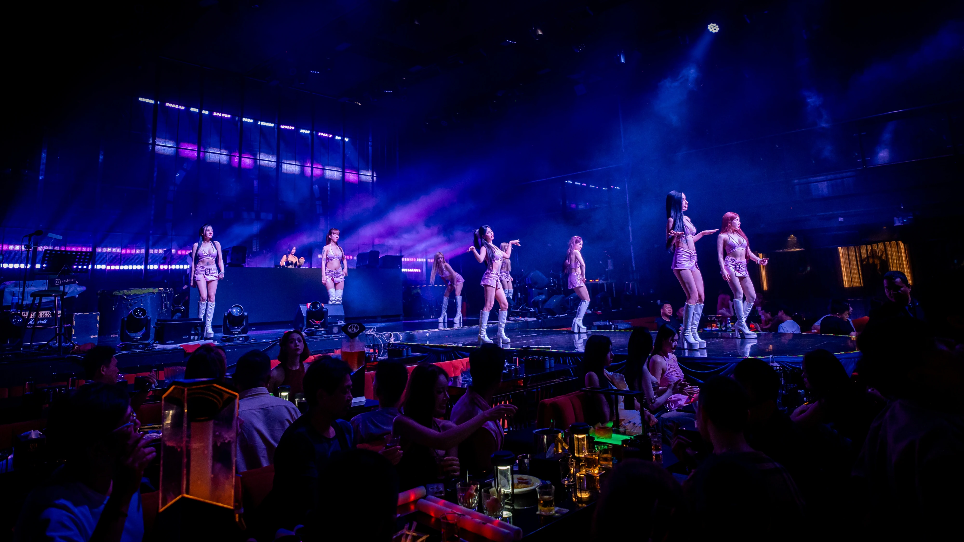 Dance performers across the blue-lit runway at Millennium Club KL, Bukit Bintang