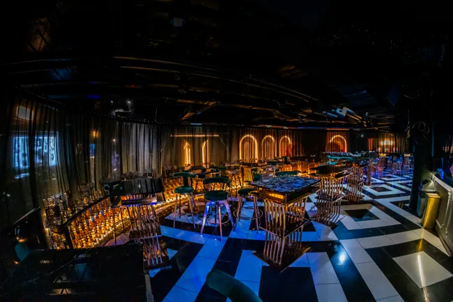 Gold arches and blue lounge seating beside the main floor at Millennium Club KL, Bukit Bintang