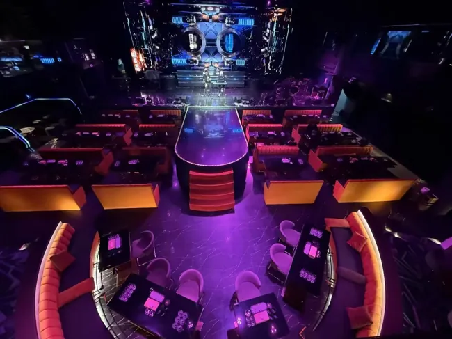 Elevated view of the runway, tables and red sofas at Millennium Club KL, Bukit Bintang