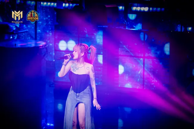 Vocalist performing in purple and blue stage lights at Millennium Club KL, Bukit Bintang