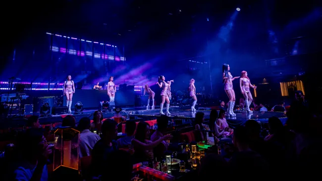 Dance performers across the blue-lit runway at Millennium Club KL, Bukit Bintang