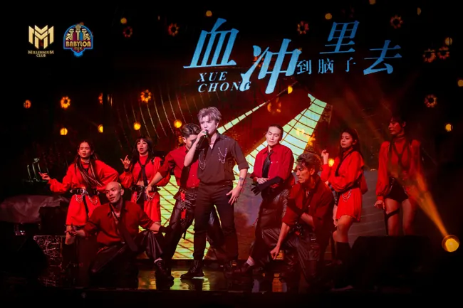 Performers across the stage in red concert lighting at Millennium Club KL, Bukit Bintang