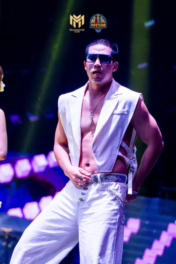 Male performer in a white suit and sunglasses under purple light at Millennium Club KL, Bukit Bintang